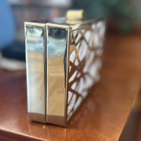 Box/minaudiere style hard clutch with gold geometric cutouts. - Picture 2 of 3